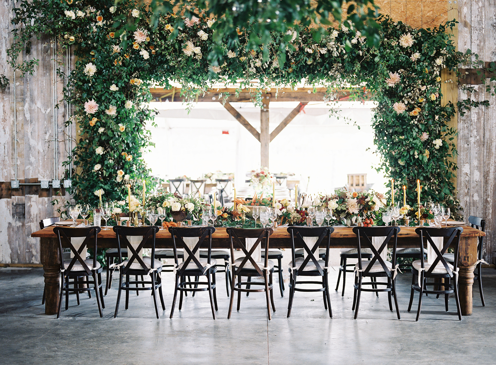 A table in front of a doorway covered with flowers