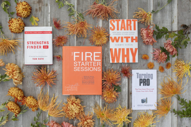 Overhead of Floret's favorite books surrounded by mums